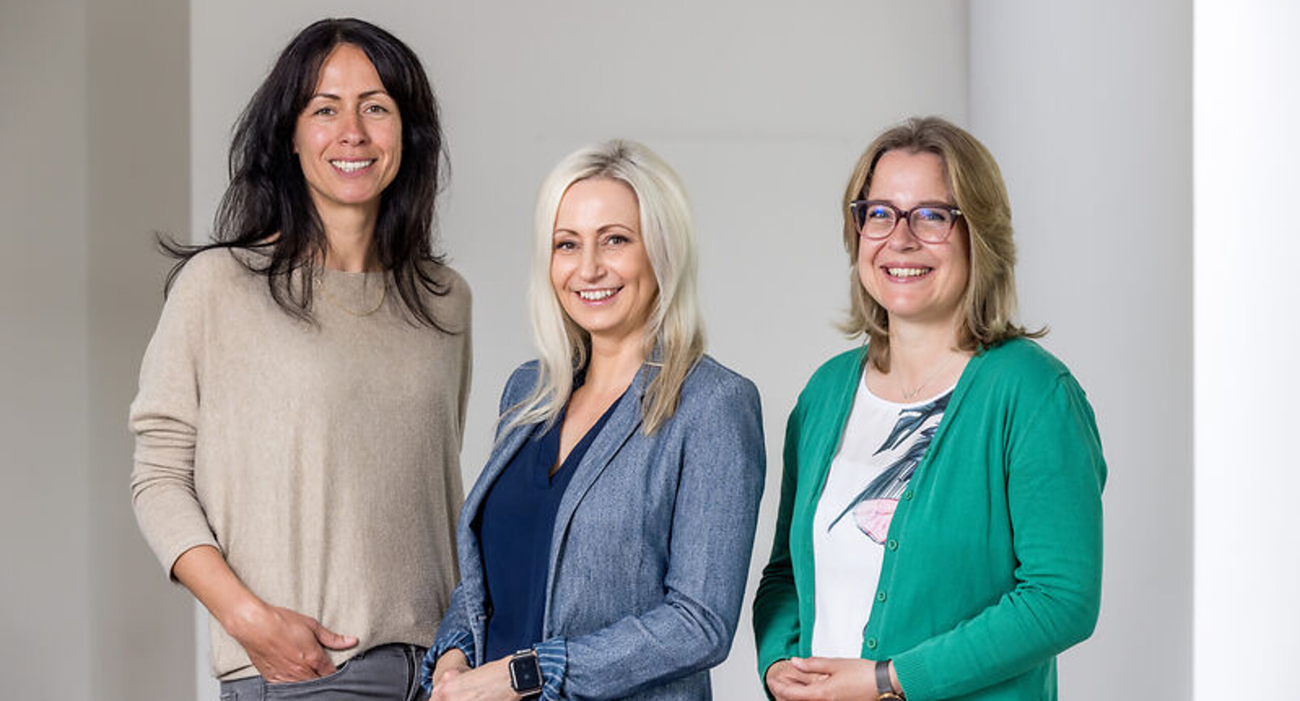 Sozialdienst Das Bild zeigt drei Frauen, die in die Kamera lächeln.